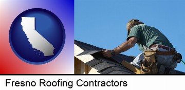 a roofing contractor installing asphalt roof shingles in Fresno, CA