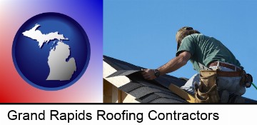 a roofing contractor installing asphalt roof shingles in Grand Rapids, MI
