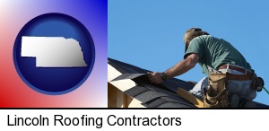 Lincoln, Nebraska - a roofing contractor installing asphalt roof shingles