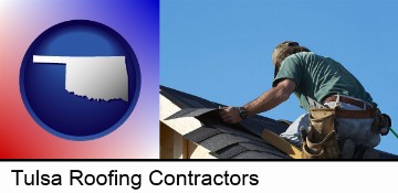 a roofing contractor installing asphalt roof shingles in Tulsa, OK