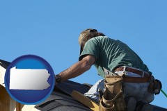 pennsylvania map icon and a roofing contractor installing asphalt roof shingles