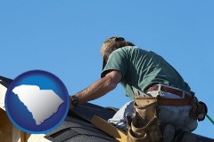 south-carolina map icon and a roofing contractor installing asphalt roof shingles