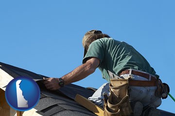 a roofing contractor installing asphalt roof shingles - with Delaware icon