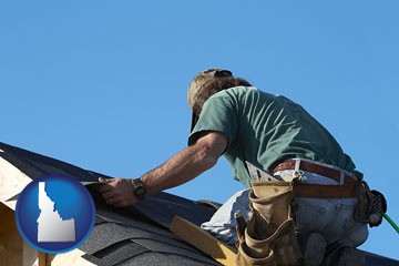 a roofing contractor installing asphalt roof shingles - with Idaho icon