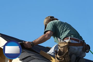 a roofing contractor installing asphalt roof shingles - with Kansas icon