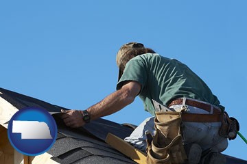 a roofing contractor installing asphalt roof shingles - with Nebraska icon