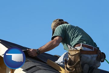 a roofing contractor installing asphalt roof shingles - with Oklahoma icon