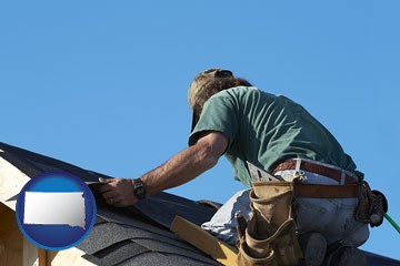 a roofing contractor installing asphalt roof shingles - with South Dakota icon