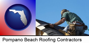 a roofing contractor installing asphalt roof shingles in Pompano Beach, FL