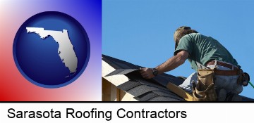 a roofing contractor installing asphalt roof shingles in Sarasota, FL